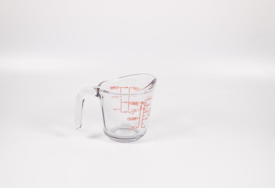pexels photo 5514785 5514785 1 A clear glass measuring cup with red markings on a white background, perfect for culinary use.